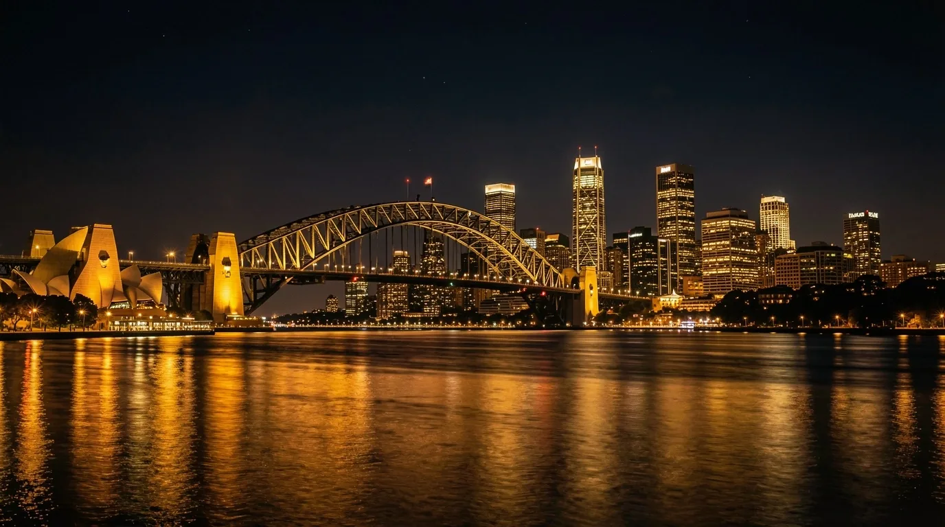 Sydney skyline at night with warm amber city glow over the harbour